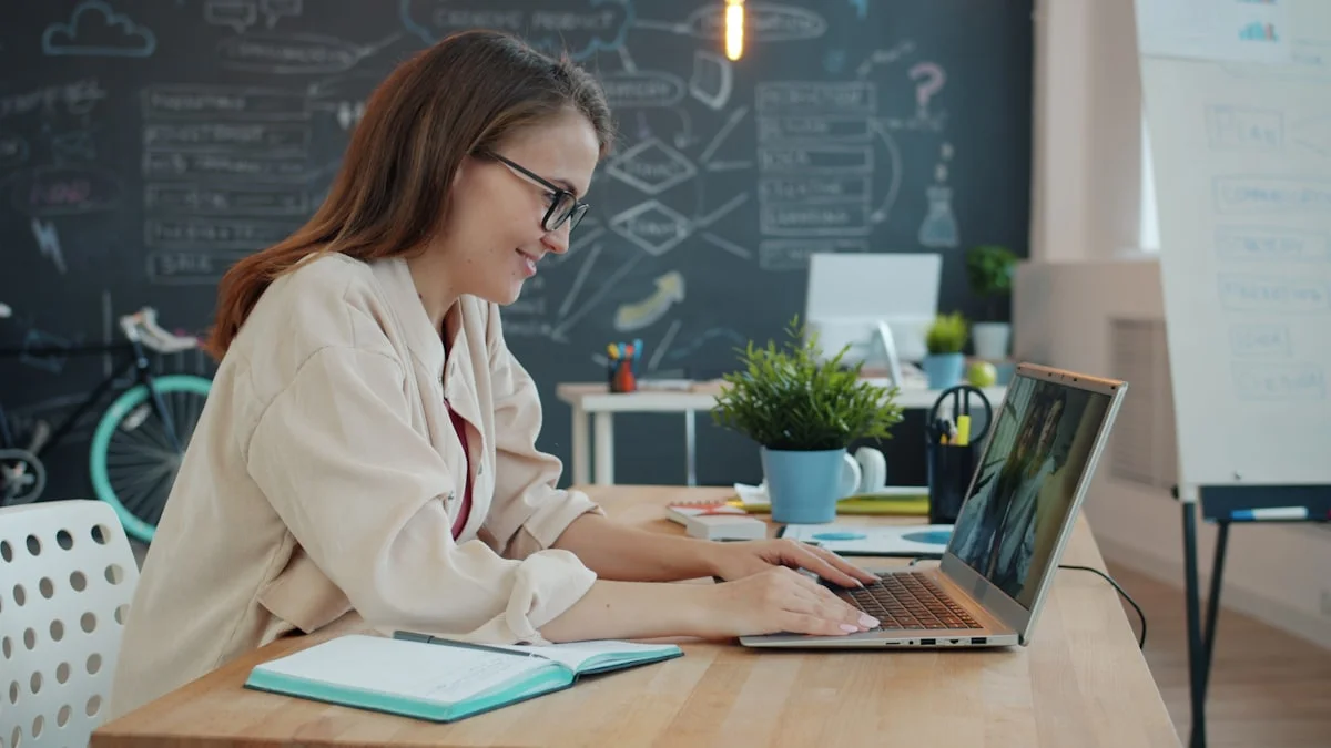 A person on a laptop video call, another participant visible on screen